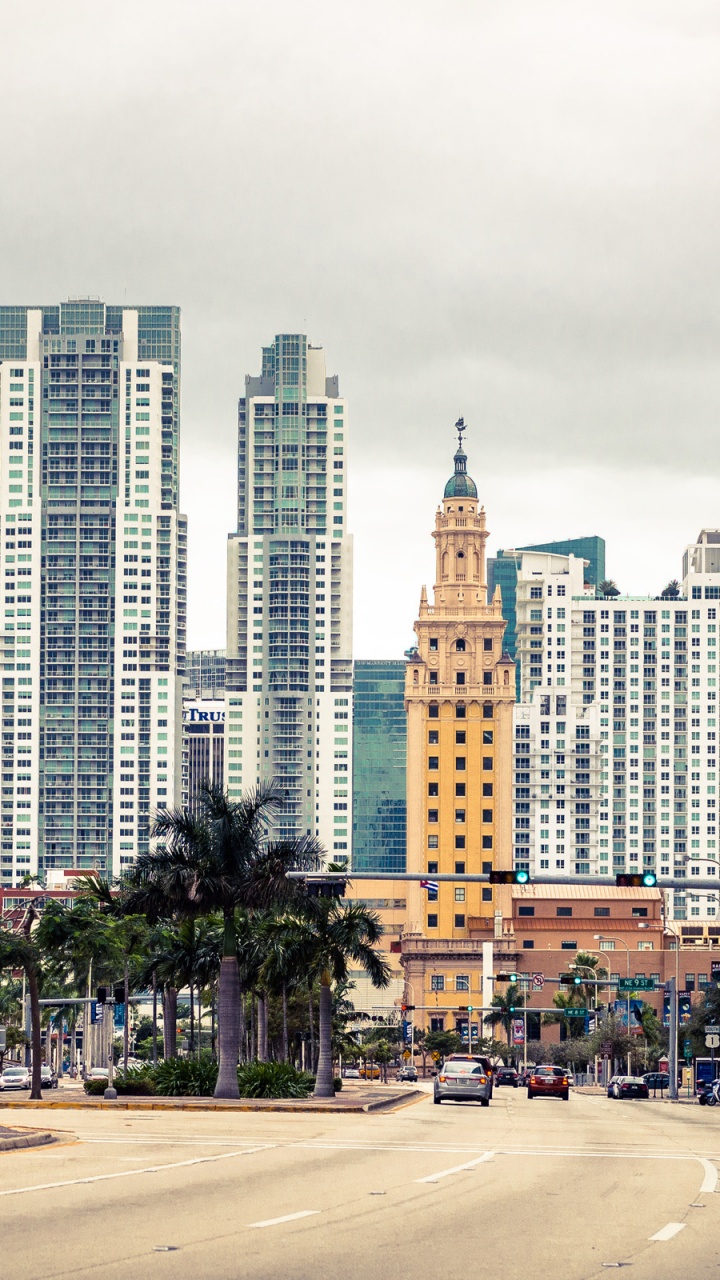 People Walking on Sidewalk Near High Rise Buildings During Daytime. Wallpaper in 720x1280 Resolution