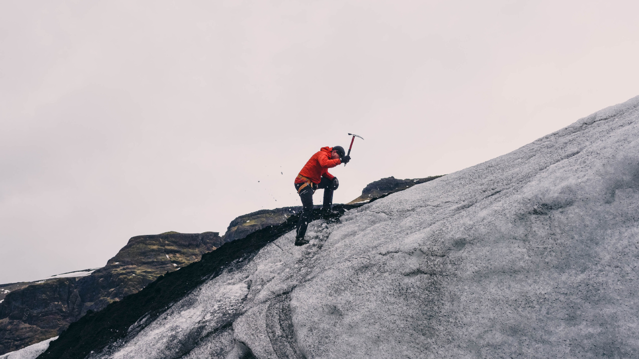 Person in Red Jacket and Black Pants Standing on Gray Rock Mountain During Daytime. Wallpaper in 1280x720 Resolution