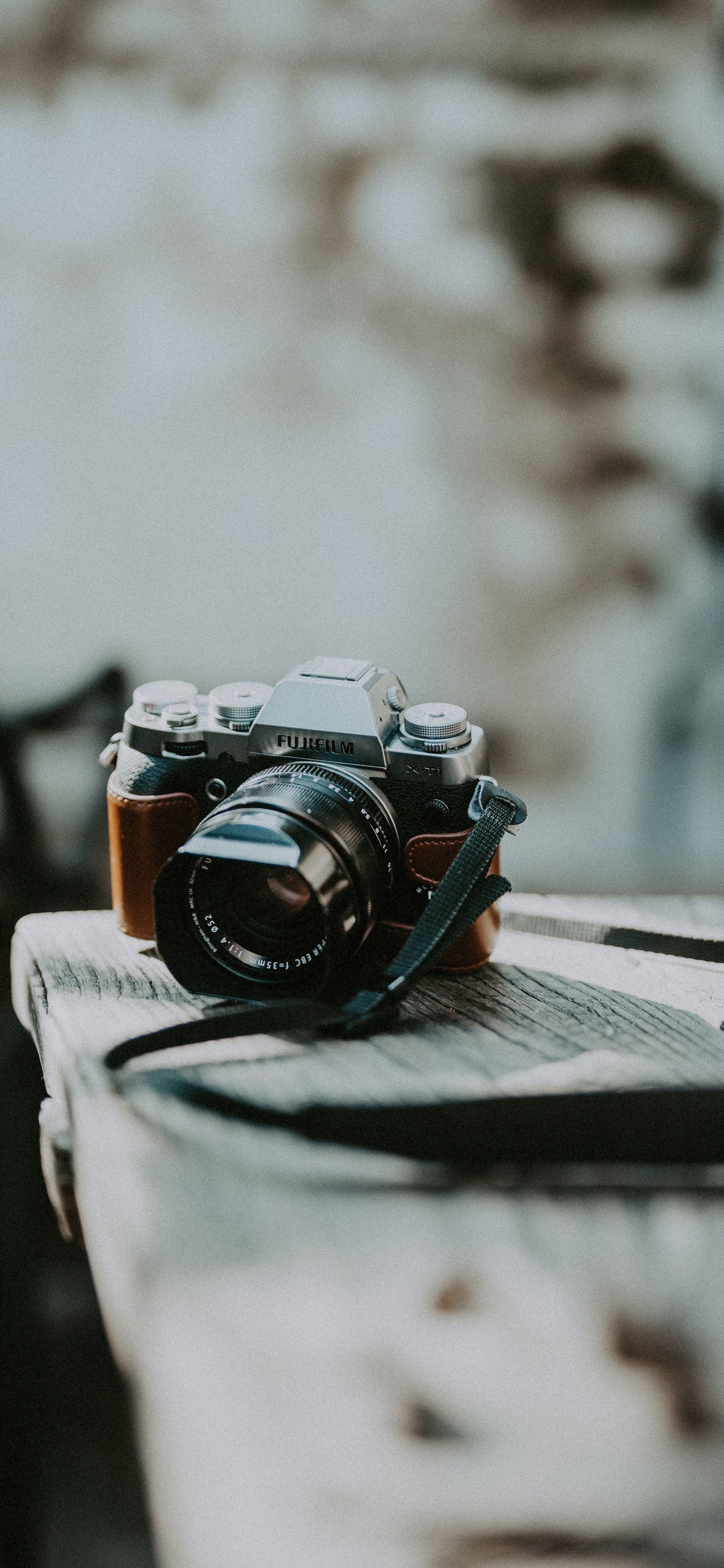 Black and Silver Dslr Camera on White Textile. Wallpaper in 1242x2688 Resolution