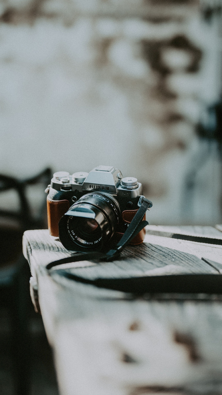 Black and Silver Dslr Camera on White Textile. Wallpaper in 750x1334 Resolution