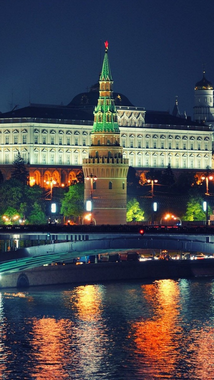 White Concrete Building Near Body of Water During Nighttime. Wallpaper in 720x1280 Resolution