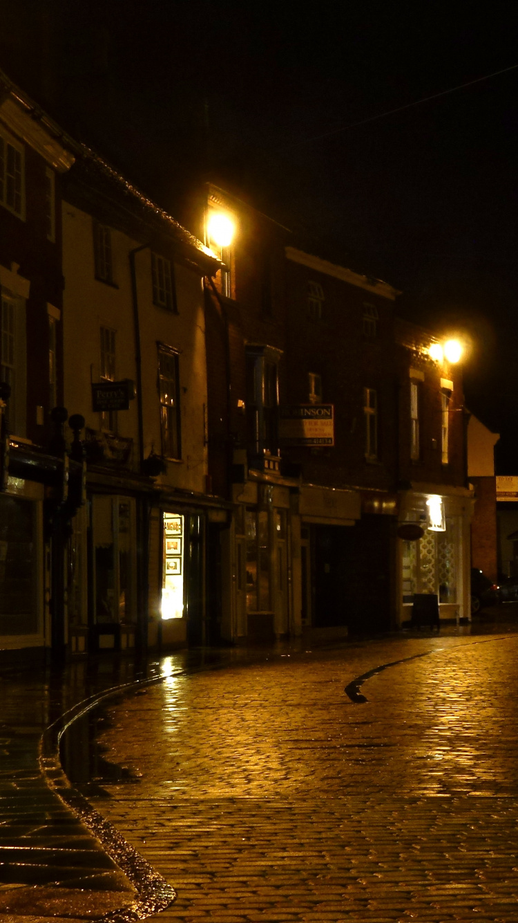 People Walking on Sidewalk Near Buildings During Night Time. Wallpaper in 750x1334 Resolution