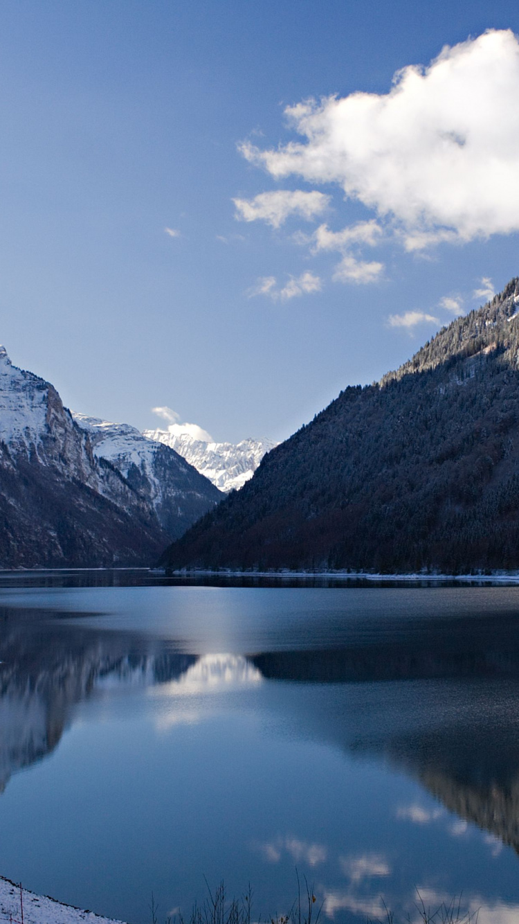 Lake Near Mountain Under Blue Sky During Daytime. Wallpaper in 750x1334 Resolution
