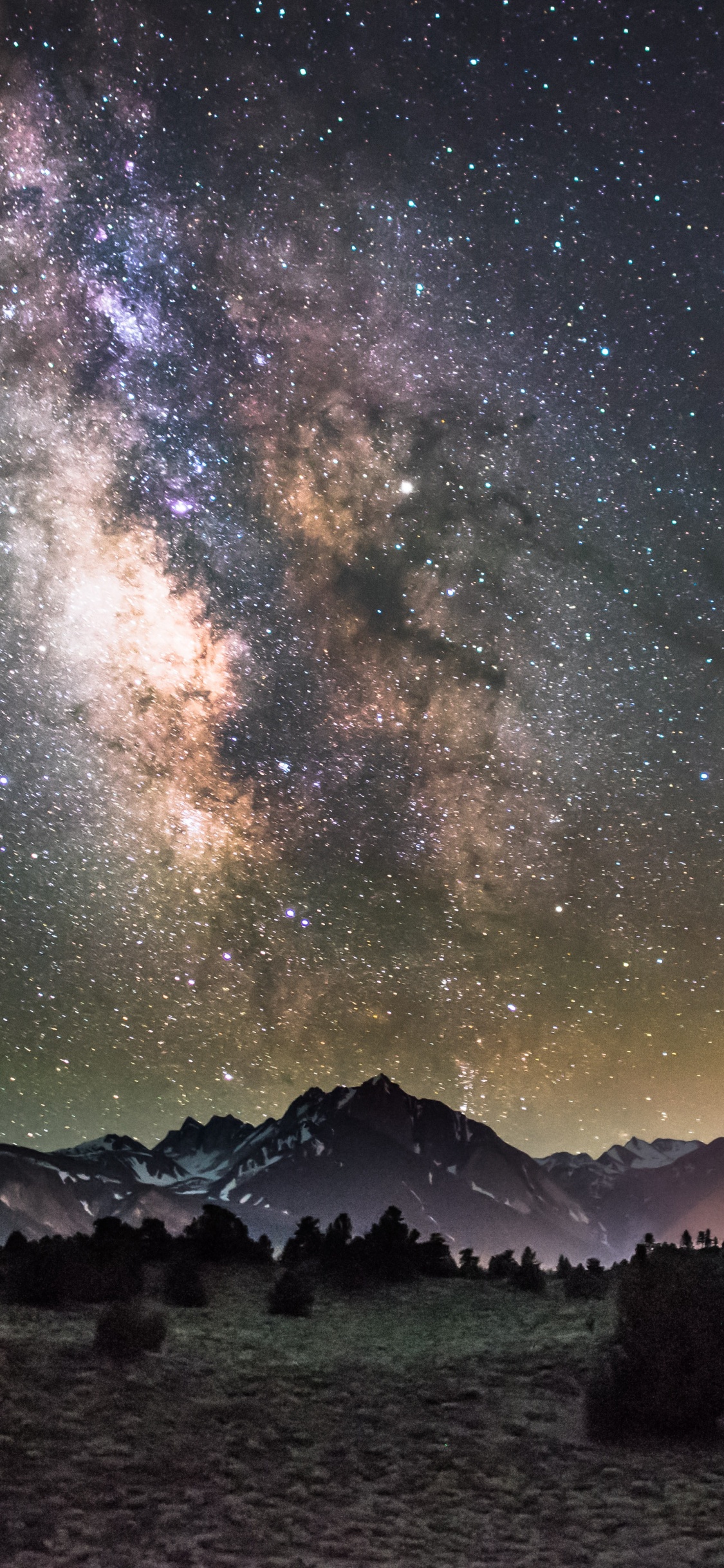 Black and White Mountain Under Blue Sky With Stars During Night Time. Wallpaper in 1125x2436 Resolution