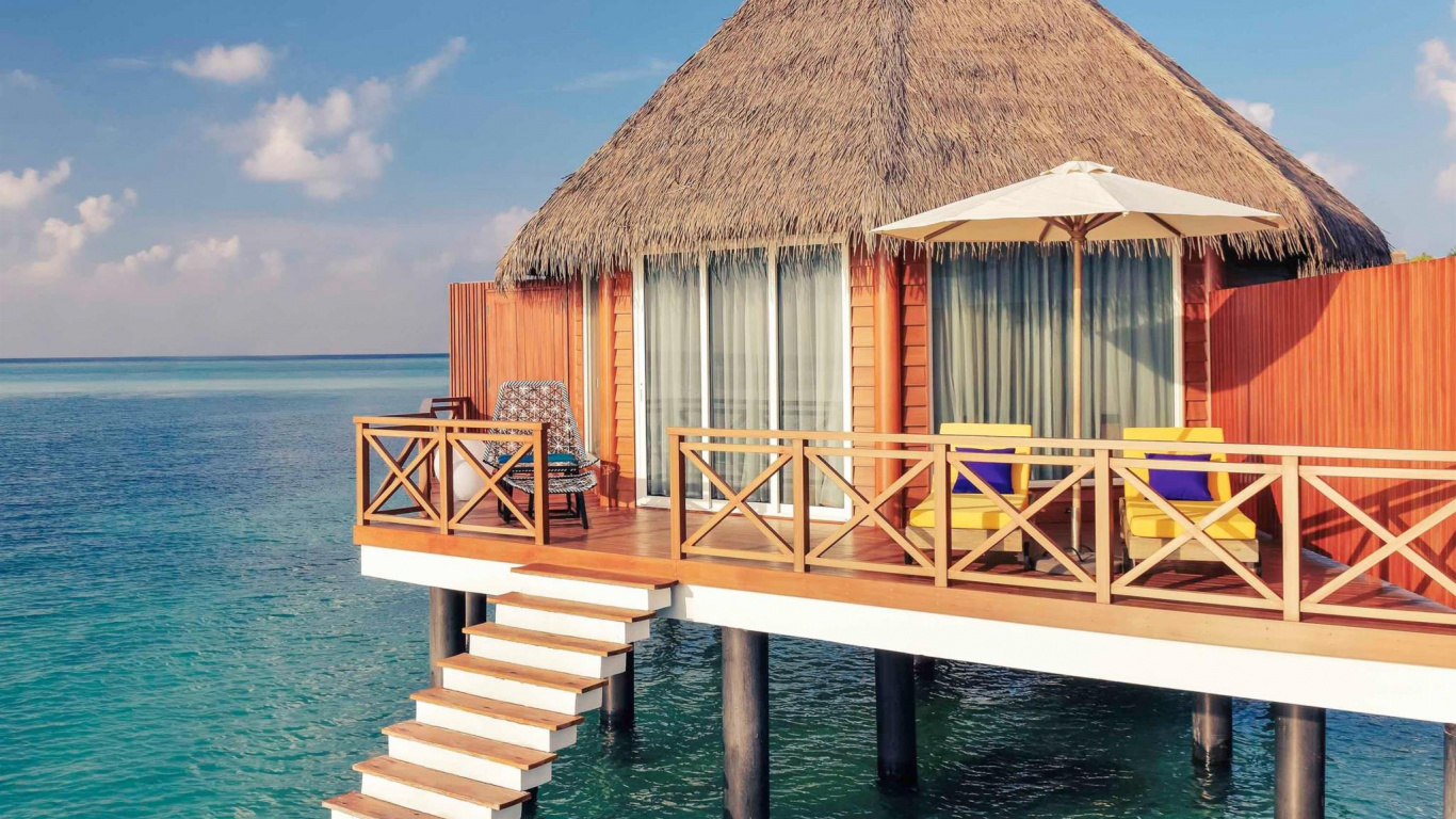 Brown Wooden House on Sea Dock Under Blue Sky During Daytime. Wallpaper in 1366x768 Resolution