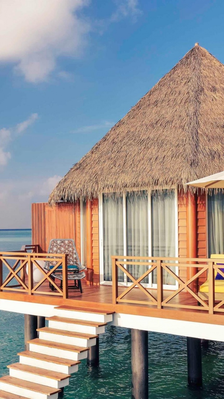 Brown Wooden House on Sea Dock Under Blue Sky During Daytime. Wallpaper in 720x1280 Resolution
