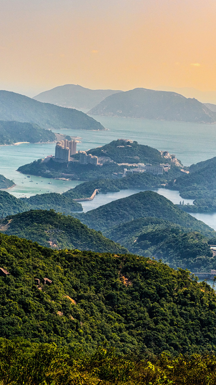 Green Mountain Beside Body of Water During Daytime. Wallpaper in 750x1334 Resolution