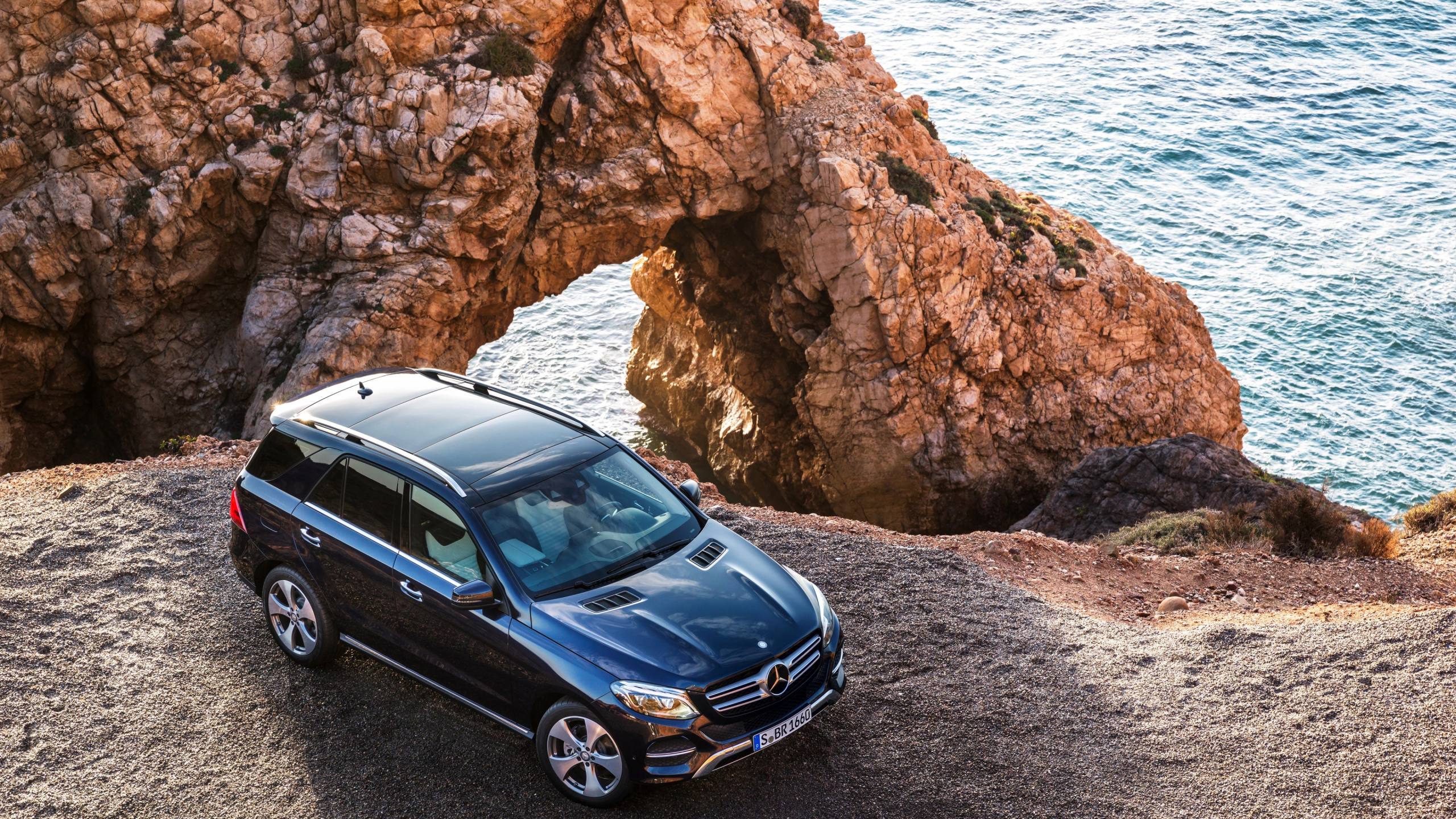 Black Mercedes Benz c Class Parked on Brown Rocky Shore During Daytime. Wallpaper in 2560x1440 Resolution