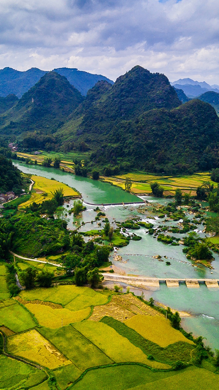 Green Grass Field and Trees Near Mountain Under White Clouds and Blue Sky During Daytime. Wallpaper in 720x1280 Resolution