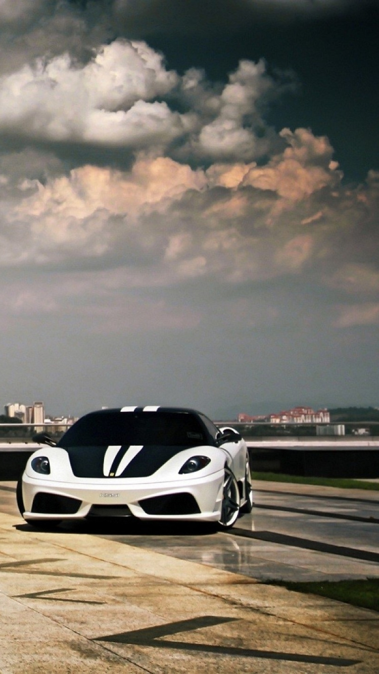 Red and White Sports Car on Road Near City Buildings During Daytime. Wallpaper in 750x1334 Resolution