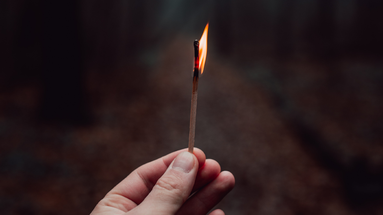 Person Holding Lighted Match Stick. Wallpaper in 1280x720 Resolution