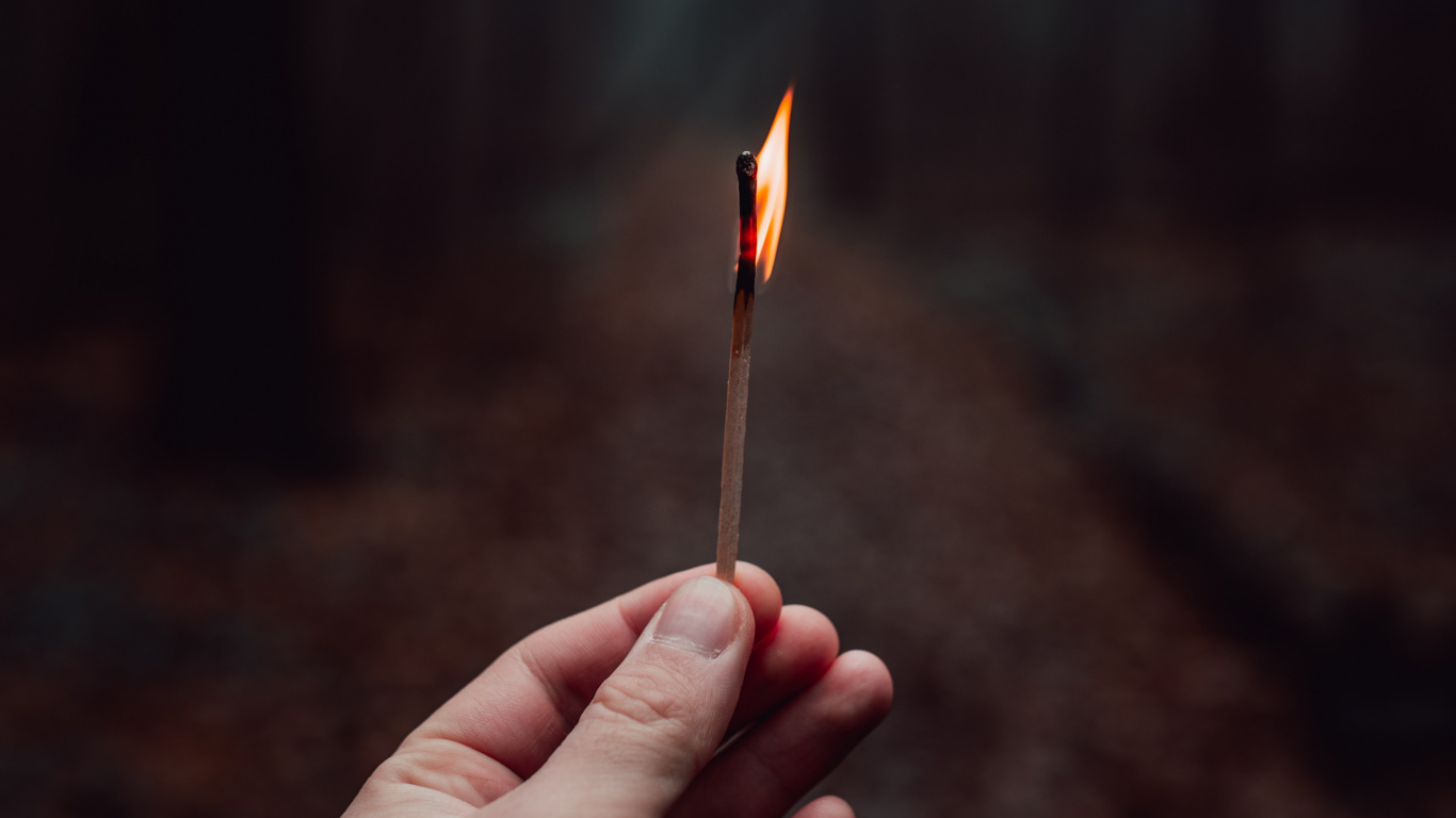 Person Holding Lighted Match Stick. Wallpaper in 1366x768 Resolution