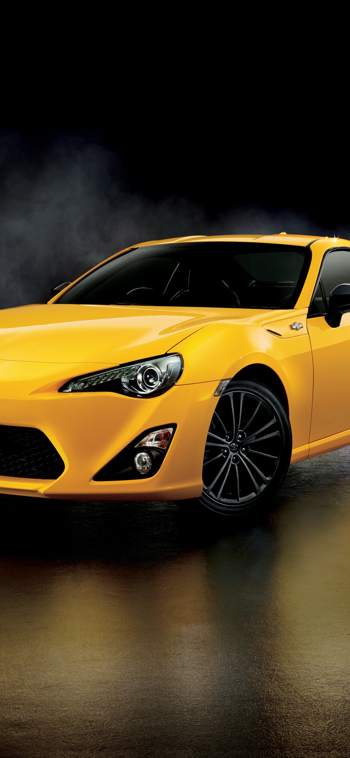 Yellow Chevrolet Camaro on Water. Wallpaper in 1125x2436 Resolution