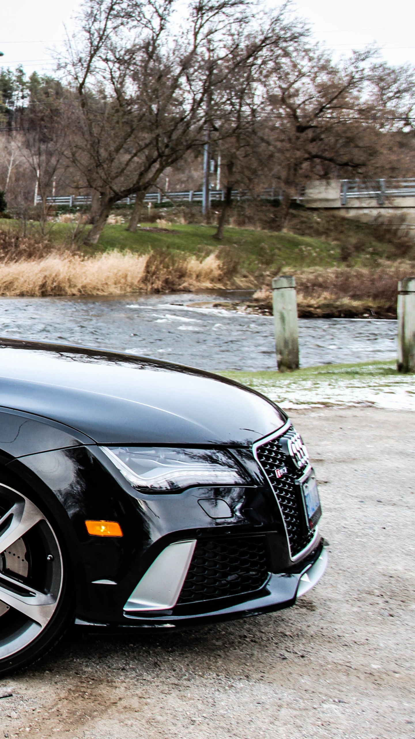 Black Sedan Parked on Gray Concrete Road During Daytime. Wallpaper in 1440x2560 Resolution