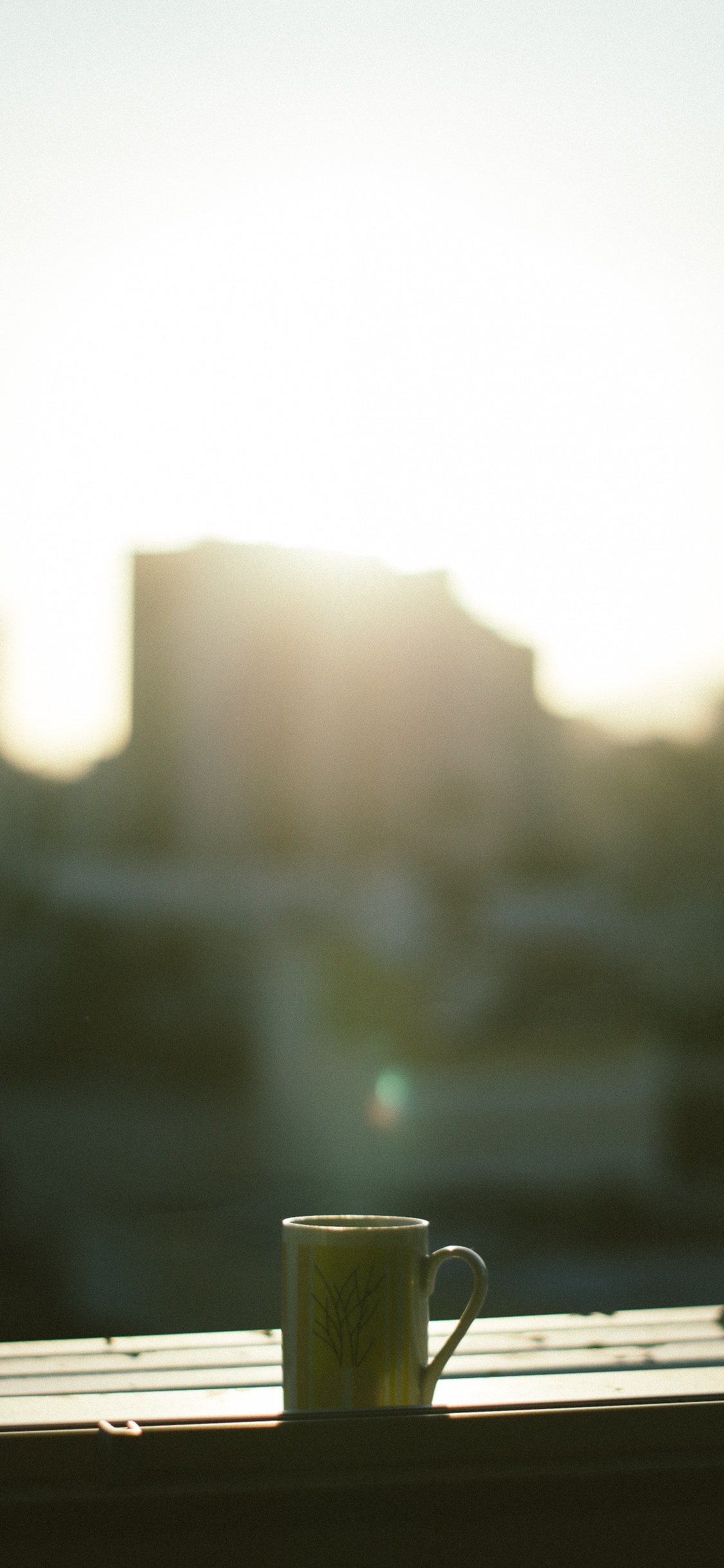 White Ceramic Mug on Table. Wallpaper in 1125x2436 Resolution