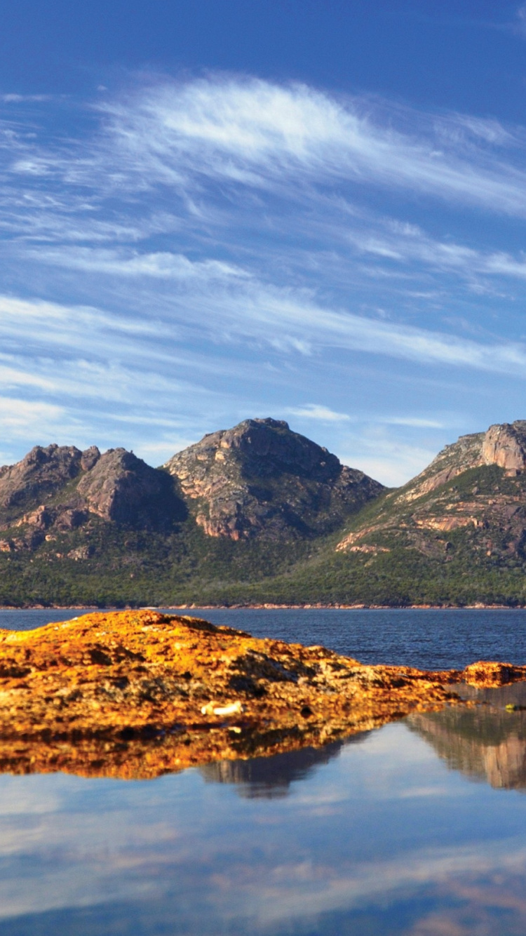 Lake Near Mountain Under Blue Sky During Daytime. Wallpaper in 750x1334 Resolution