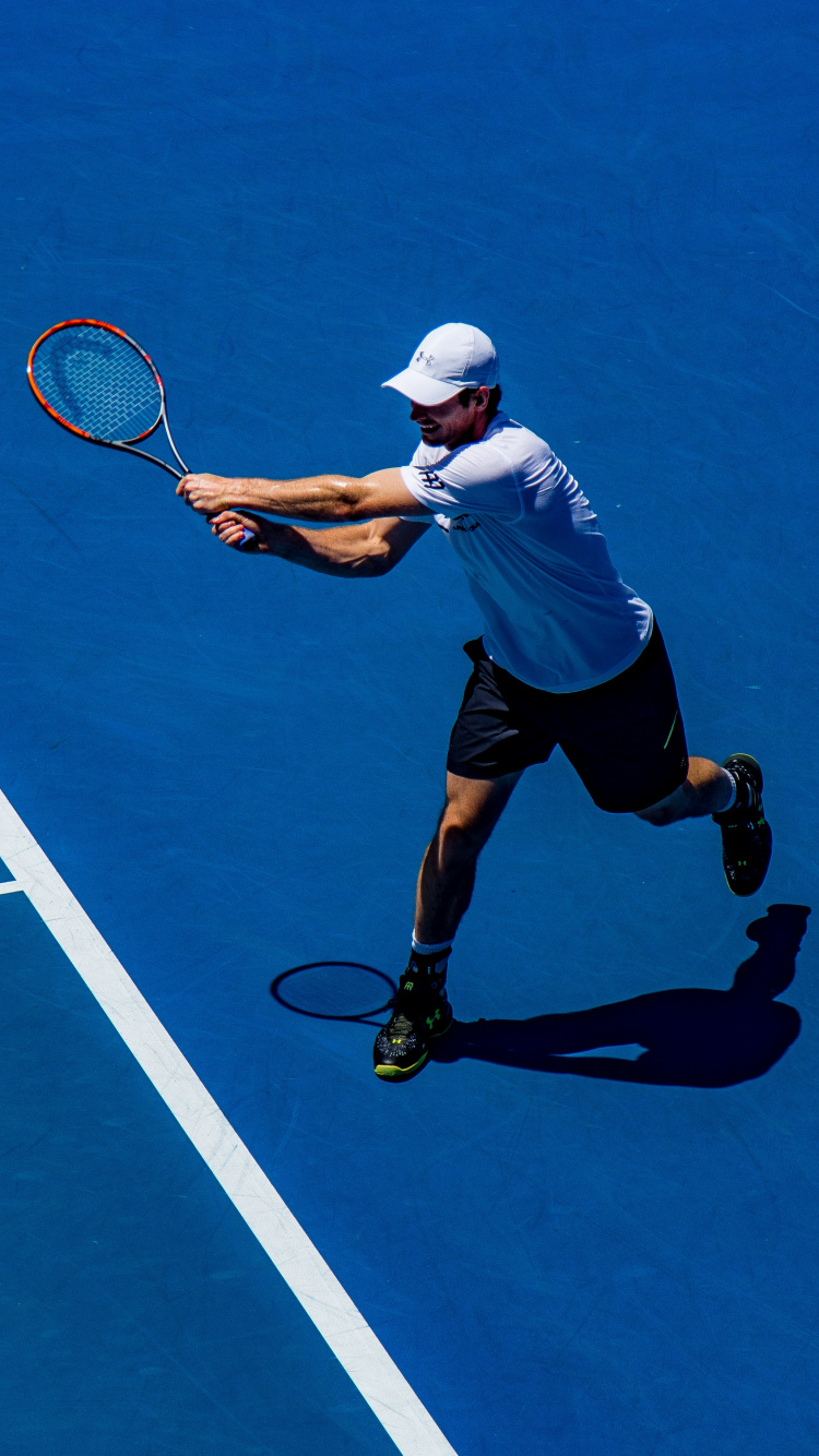 Man in White Shirt and Black Shorts Playing Tennis. Wallpaper in 750x1334 Resolution