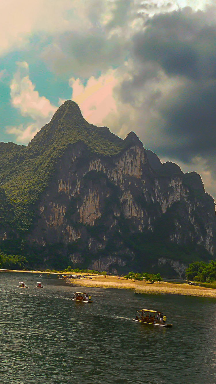 People Riding Boat on Sea Near Mountain During Daytime. Wallpaper in 750x1334 Resolution