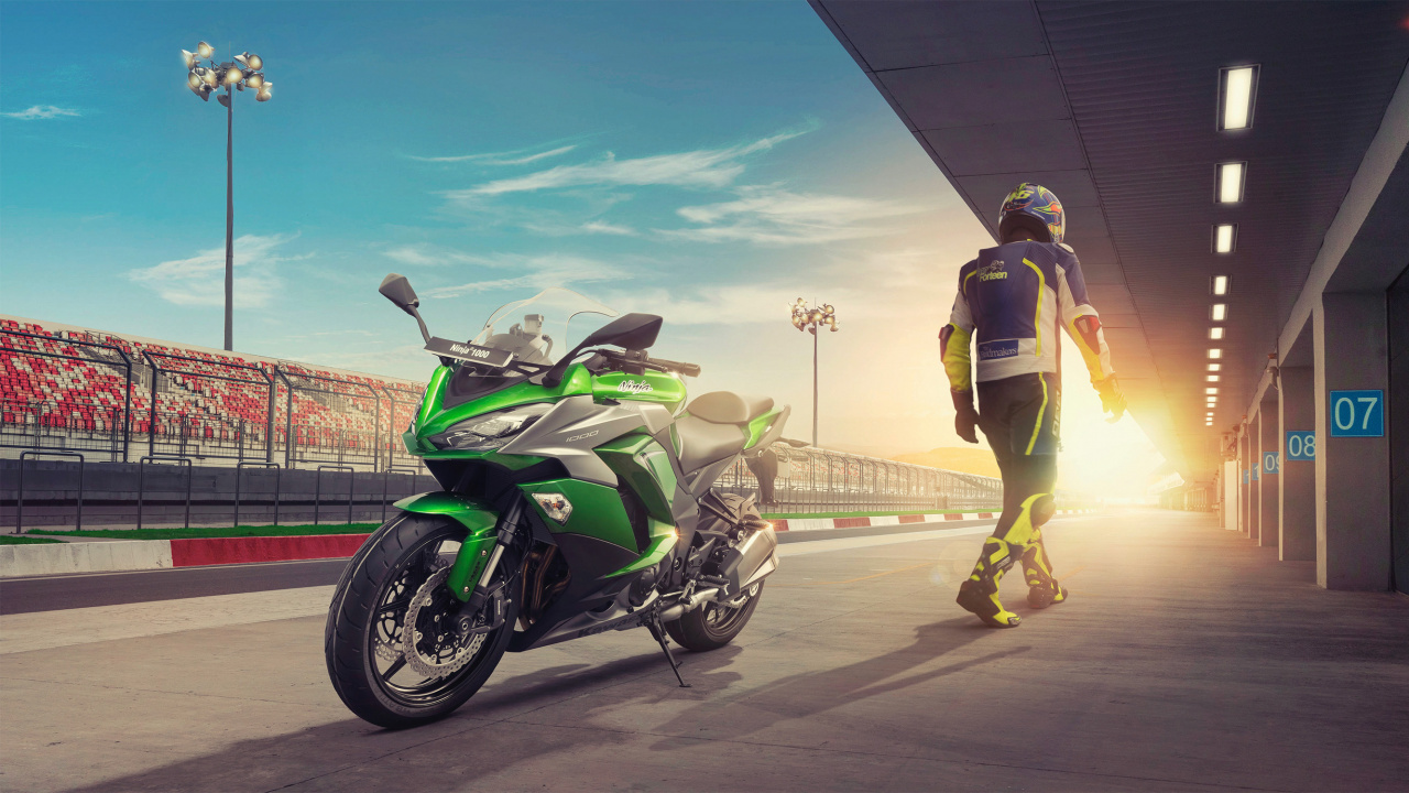 Man in Brown Jacket and Yellow Pants Riding on Black and White Sports Bike During Daytime. Wallpaper in 1280x720 Resolution