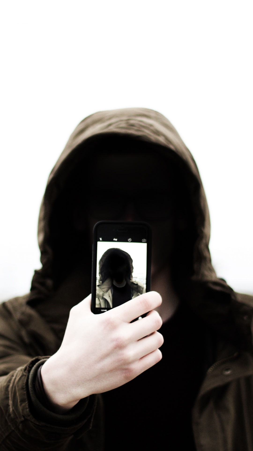 Grayscale Photo of Man in Hoodie Holding Phone. Wallpaper in 1080x1920 Resolution