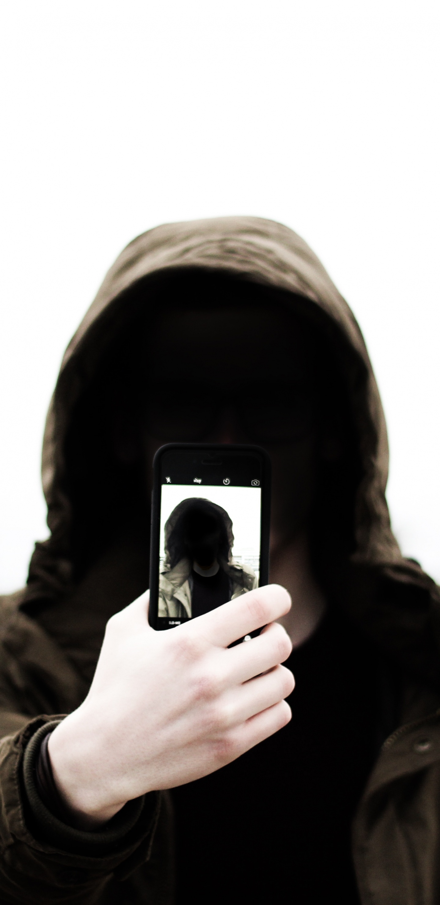Grayscale Photo of Man in Hoodie Holding Phone. Wallpaper in 1440x2960 Resolution
