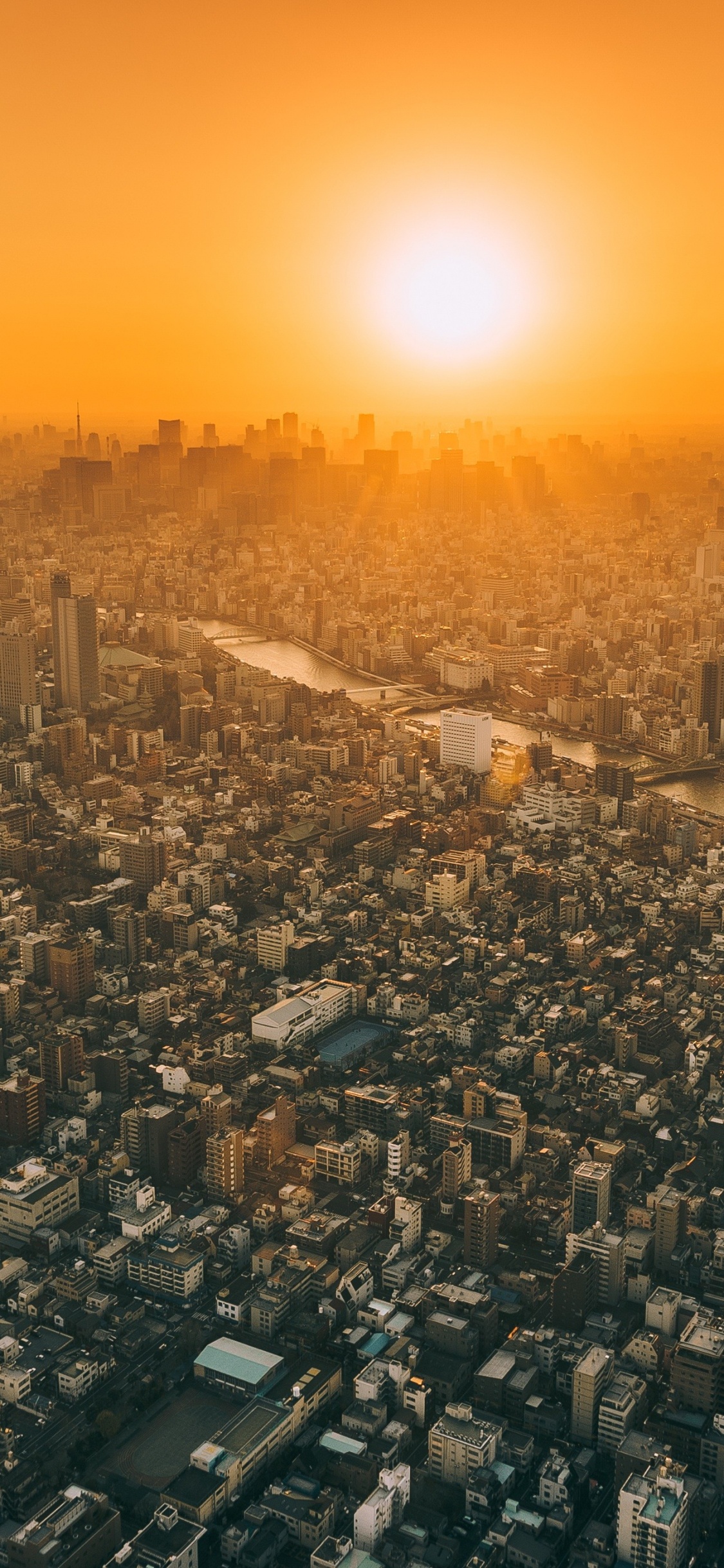 Vista Aérea de la Ciudad Durante la Puesta de Sol. Wallpaper in 1125x2436 Resolution