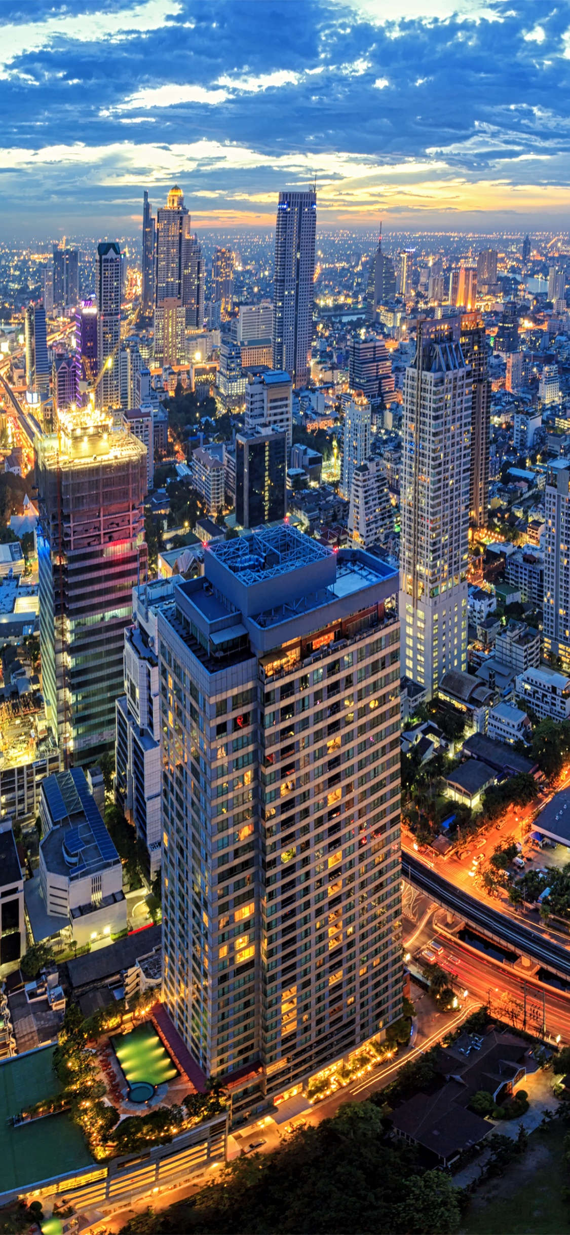 Aerial View of City Buildings During Night Time. Wallpaper in 1125x2436 Resolution
