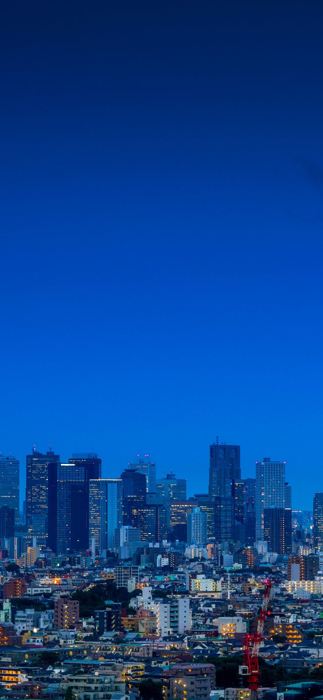 City With High Rise Buildings Under Blue Sky During Daytime. Wallpaper in 1125x2436 Resolution