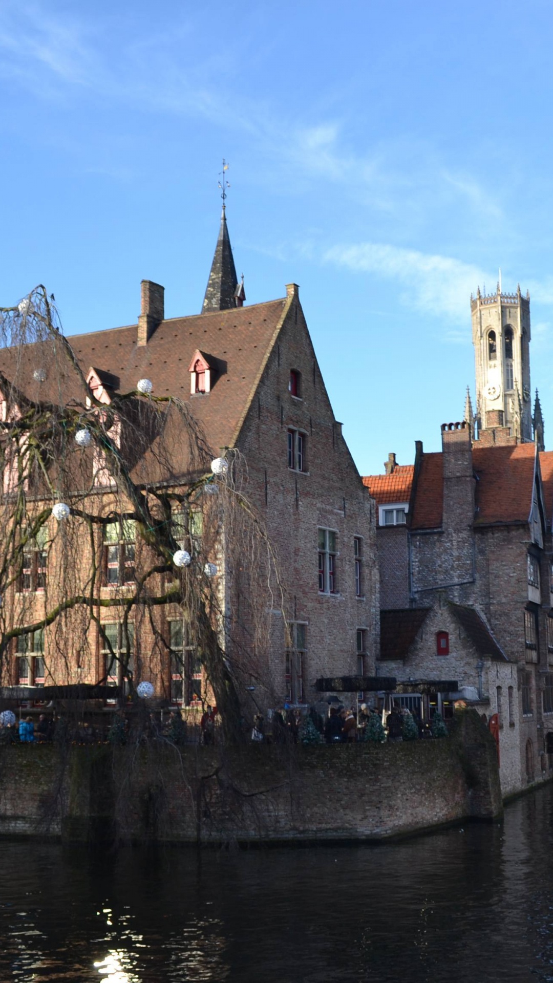 Brown Concrete Building Beside Body of Water During Daytime. Wallpaper in 1080x1920 Resolution