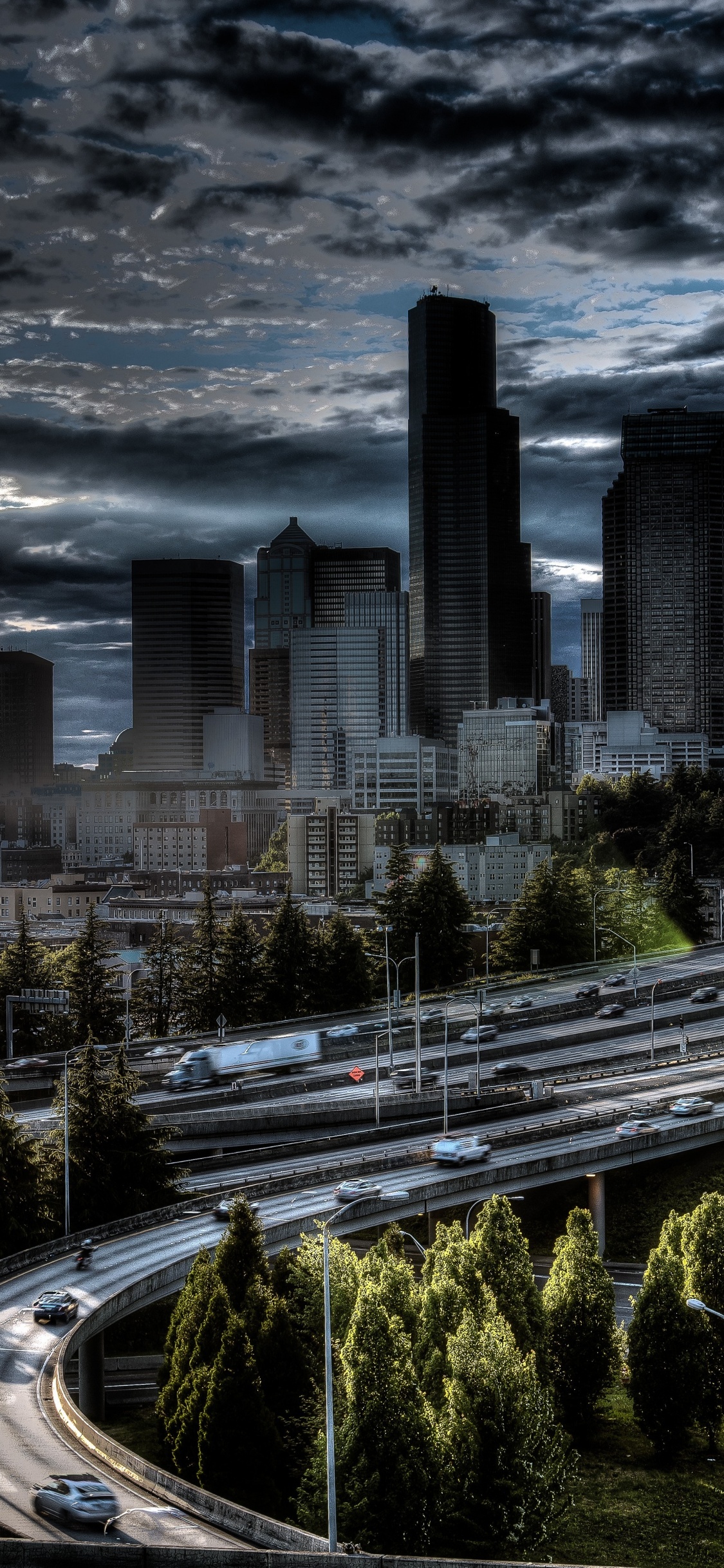 City Buildings Under Gray Clouds During Daytime. Wallpaper in 1125x2436 Resolution