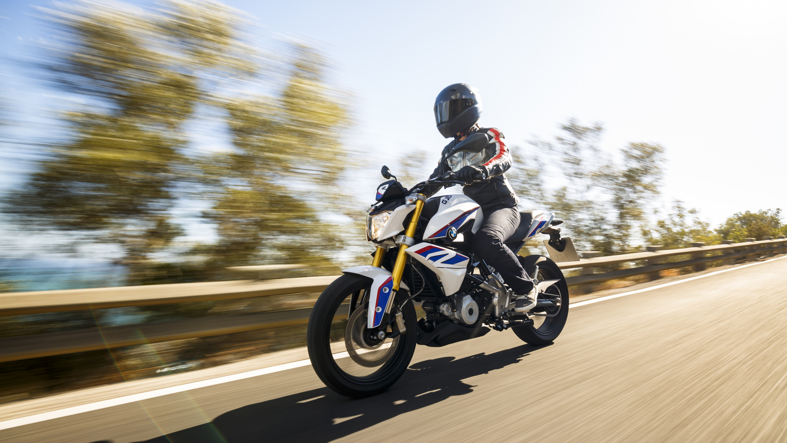 Man in Black Jacket Riding Motorcycle on Road During Daytime. Wallpaper in 2560x1440 Resolution