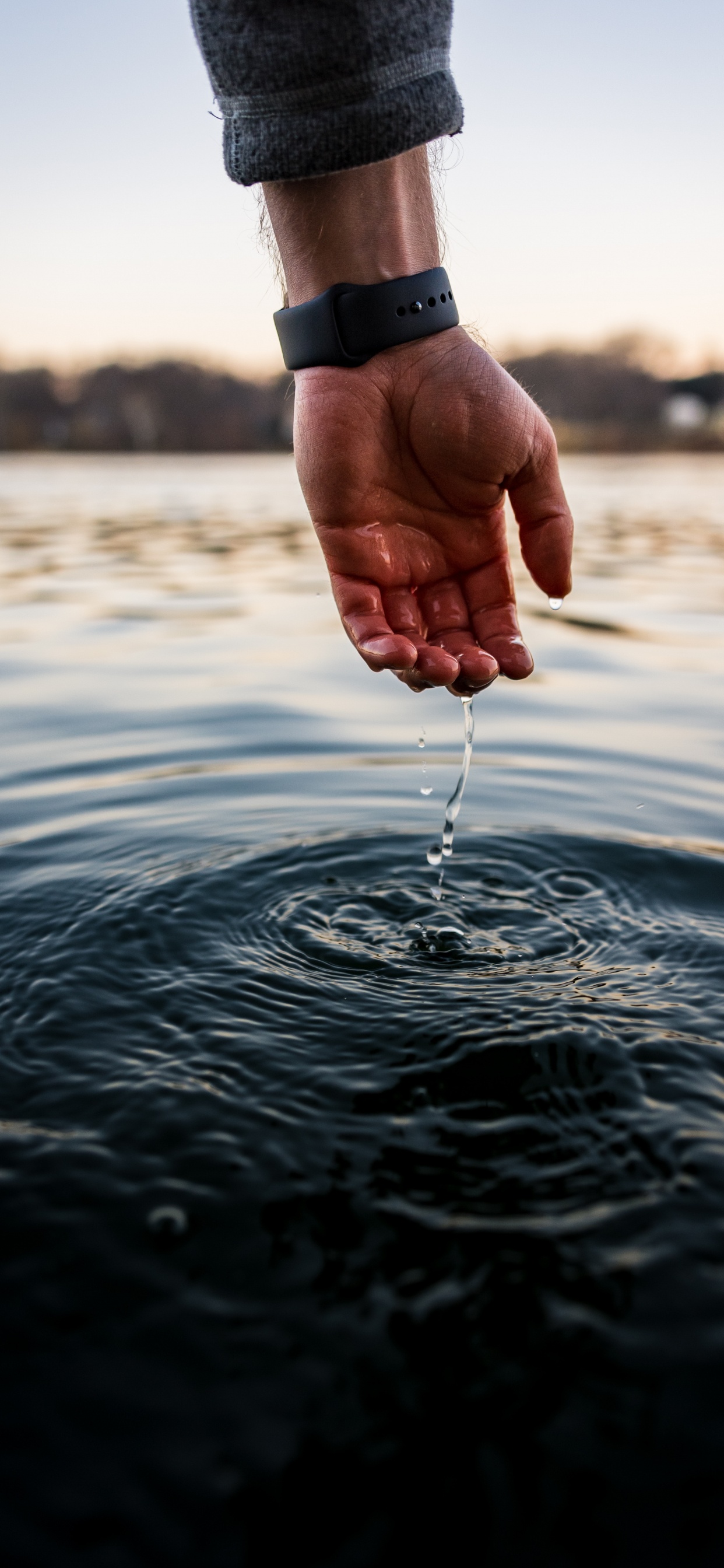 Persona Que Sostiene la Manguera de Agua en el Agua Durante el Día. Wallpaper in 1242x2688 Resolution