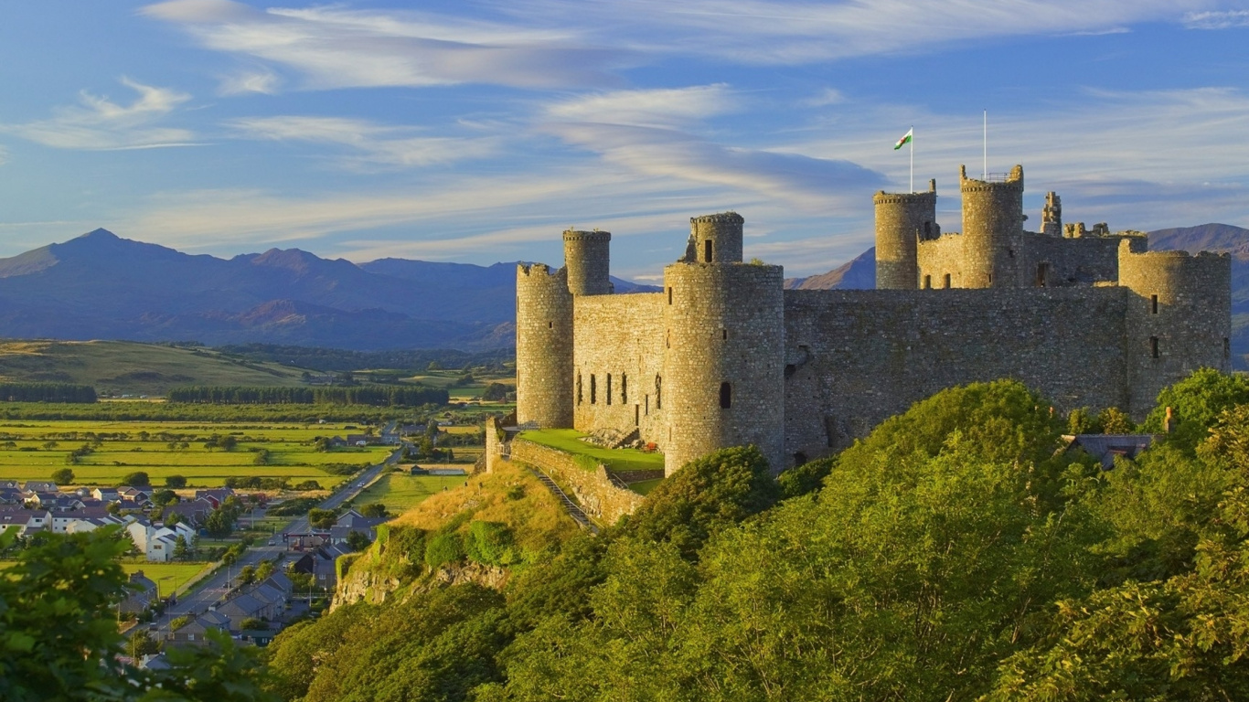 Gray Concrete Castle on Green Grass Field Under White Clouds and Blue Sky During Daytime. Wallpaper in 1366x768 Resolution