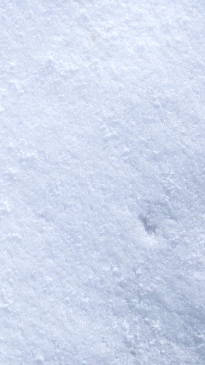 Person in Black Shoes Standing on Snow Covered Ground. Wallpaper in 720x1280 Resolution