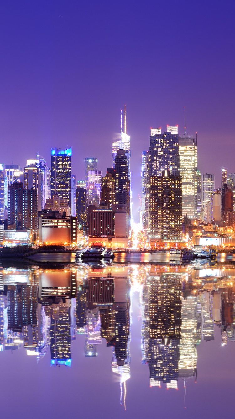 City Skyline Across Body of Water During Night Time. Wallpaper in 750x1334 Resolution