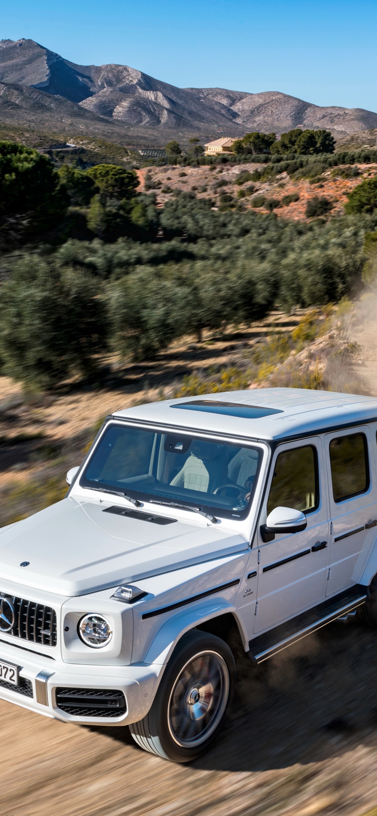 White Suv on Dirt Road During Daytime. Wallpaper in 1242x2688 Resolution