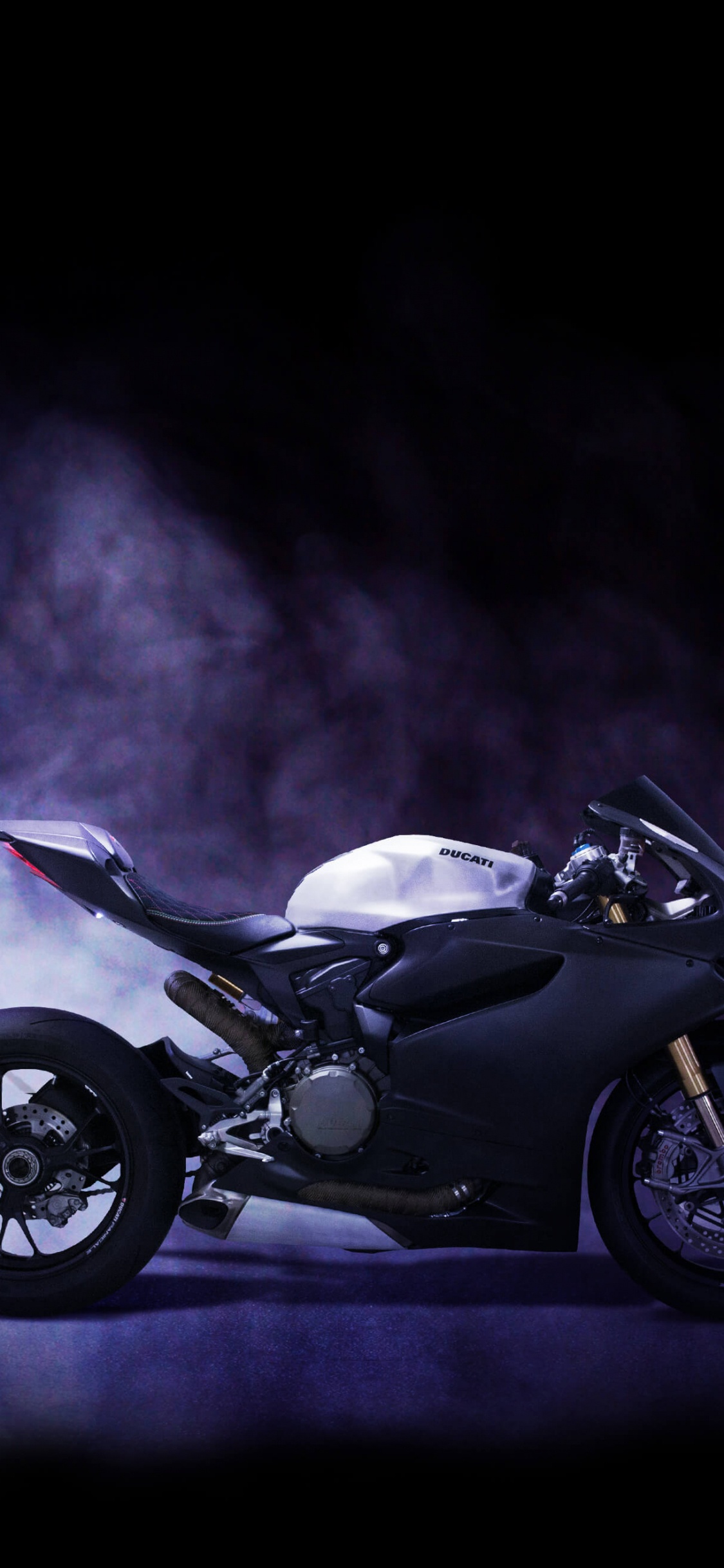Black and Silver Motorcycle in a Dark Room. Wallpaper in 1125x2436 Resolution
