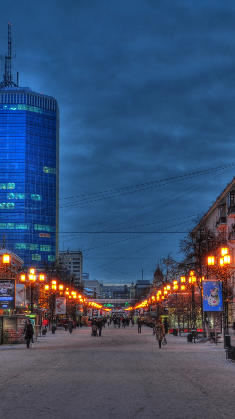 People Walking on Sidewalk Near High Rise Buildings During Night Time. Wallpaper in 750x1334 Resolution