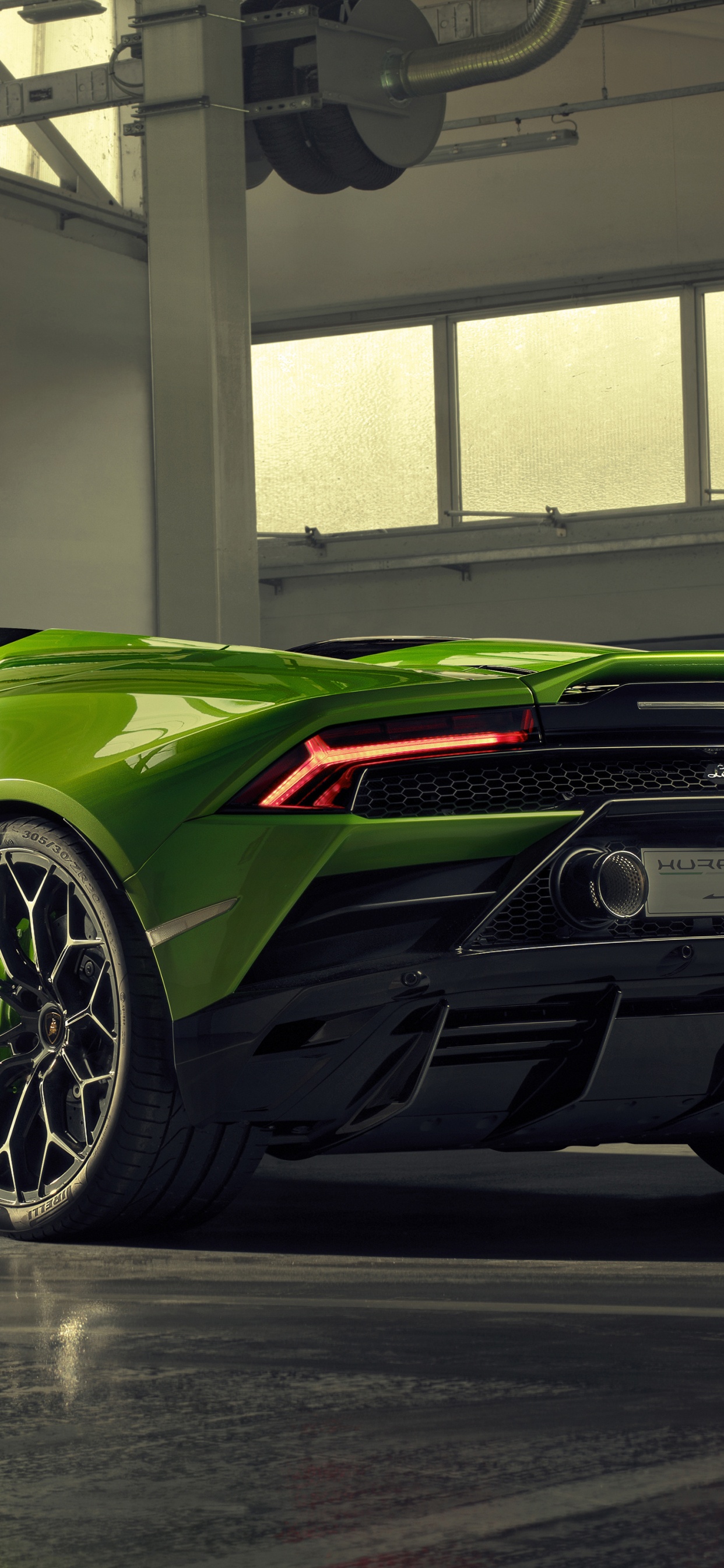 Green Porsche 911 Parked in Building. Wallpaper in 1242x2688 Resolution