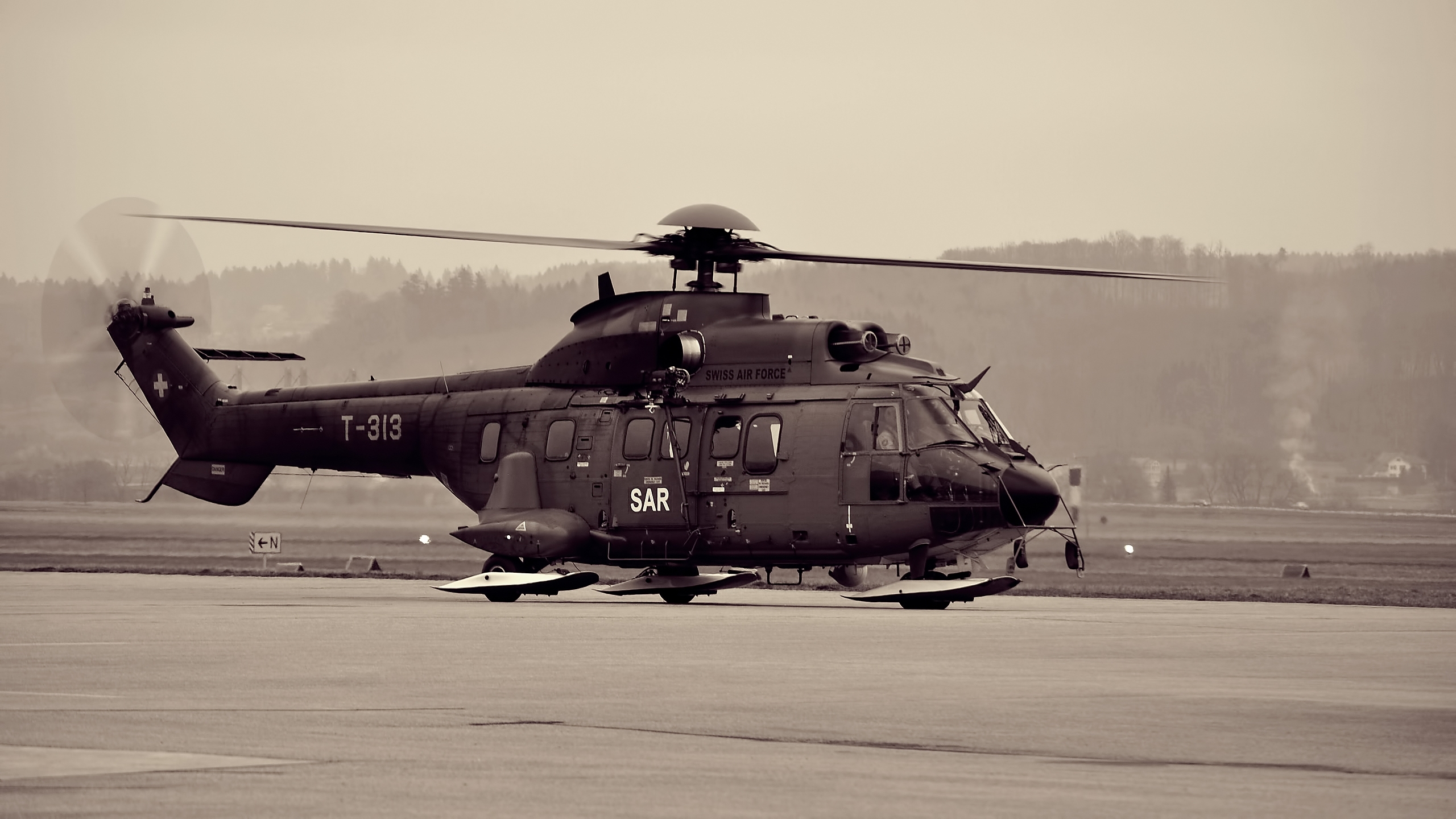 Black and White Helicopter on Gray Field During Daytime. Wallpaper in 2560x1440 Resolution