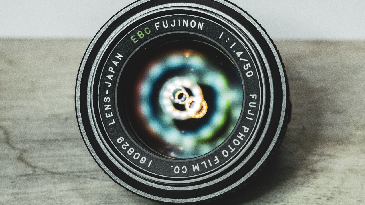 Black Round Camera Lens on Brown Wooden Table. Wallpaper in 1280x720 Resolution