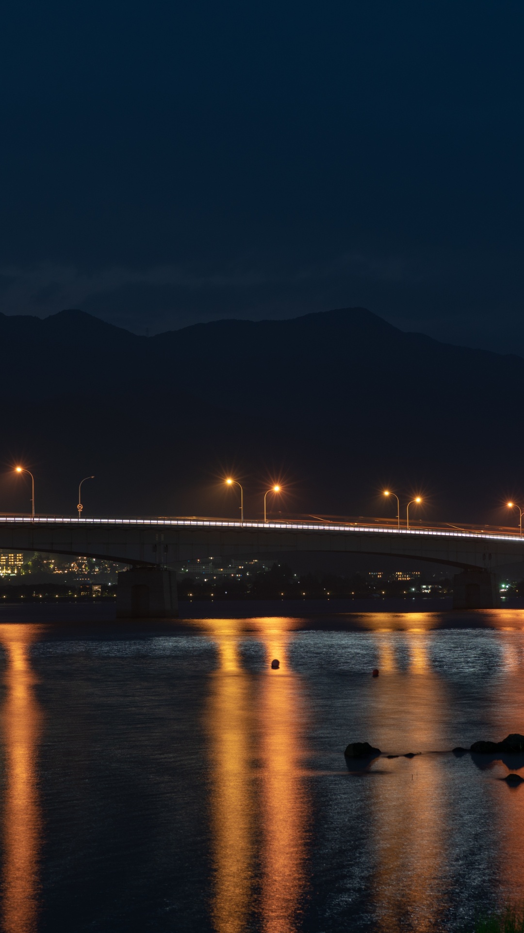 Beleuchtete Brücke Über Wasser Während Der Nacht Night. Wallpaper in 1080x1920 Resolution