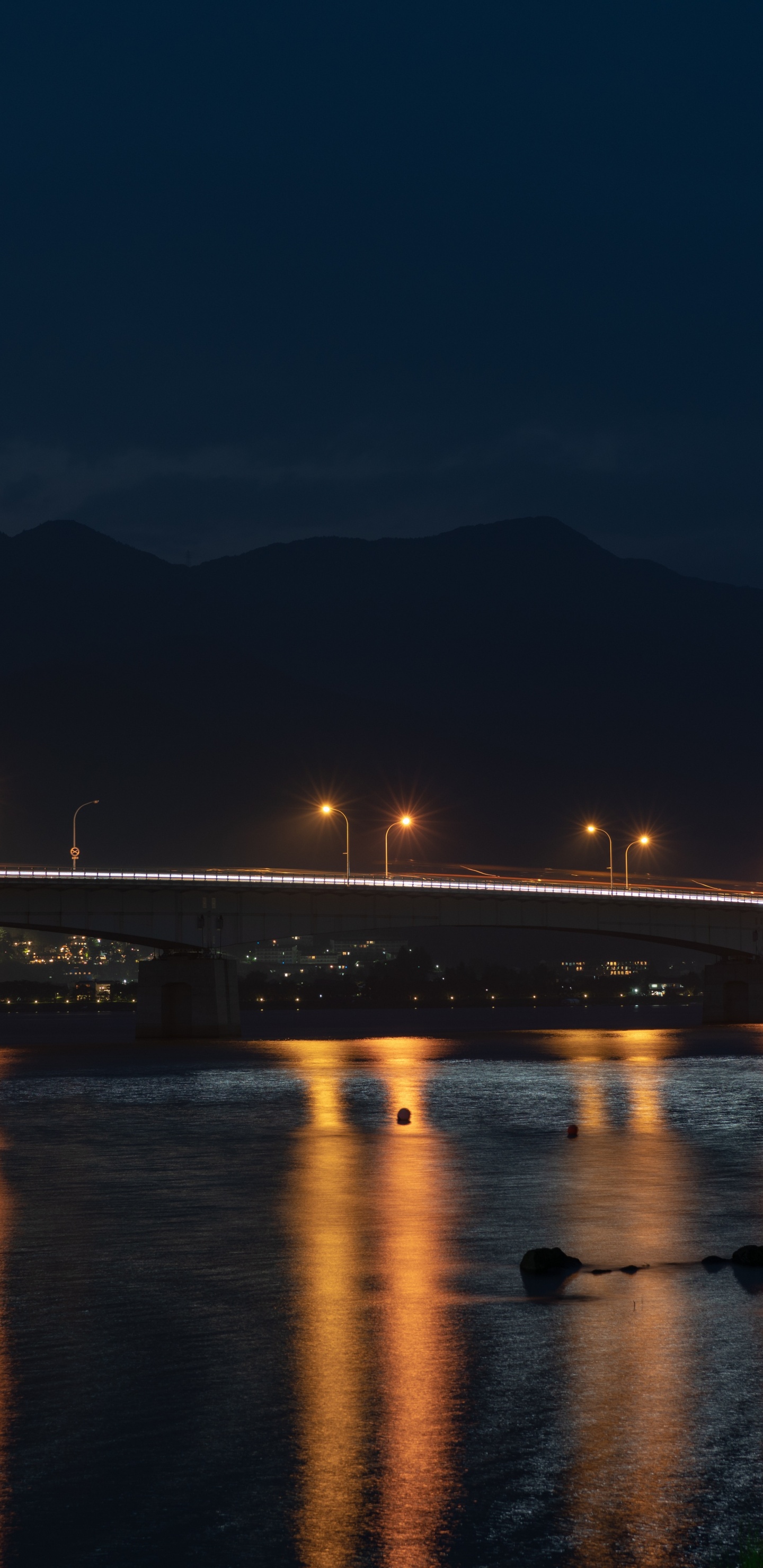 Beleuchtete Brücke Über Wasser Während Der Nacht Night. Wallpaper in 1440x2960 Resolution