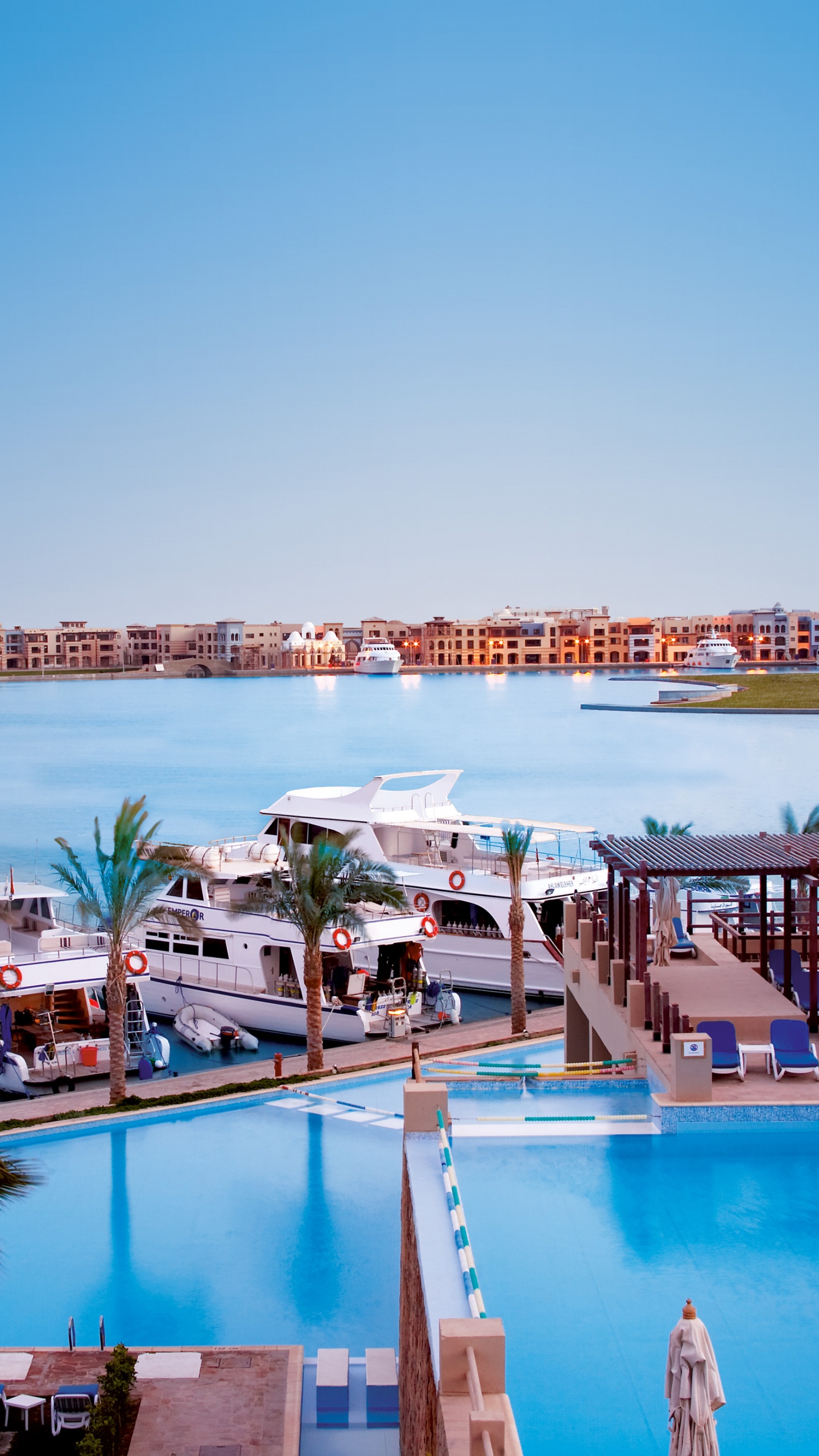 Swimming Pool Near Brown Wooden Dock During Daytime. Wallpaper in 1440x2560 Resolution