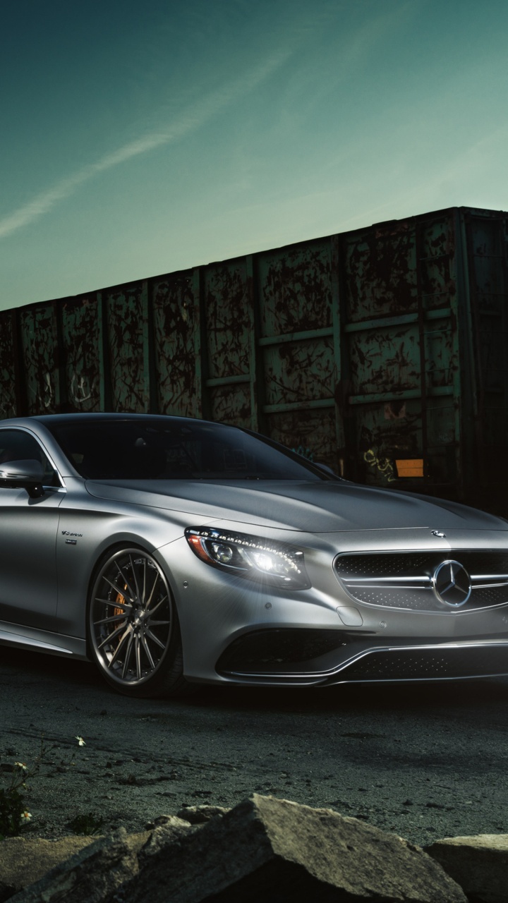 Silver Mercedes Benz Coupe Parked Beside Brown Brick Wall. Wallpaper in 720x1280 Resolution