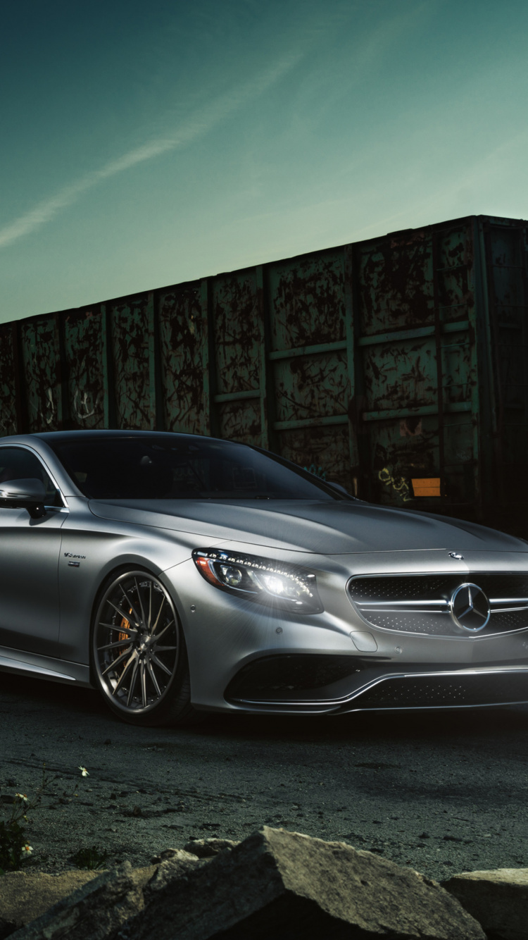 Silver Mercedes Benz Coupe Parked Beside Brown Brick Wall. Wallpaper in 750x1334 Resolution