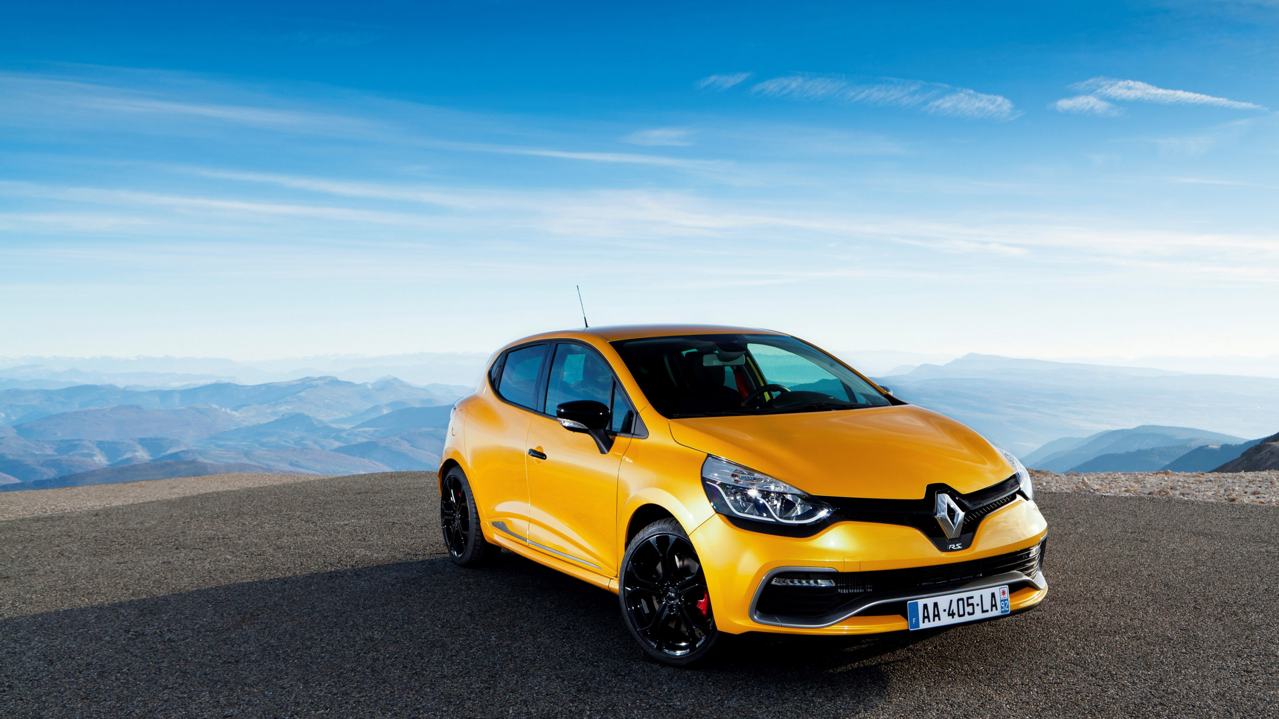Yellow Sedan on Brown Sand Under Blue Sky During Daytime. Wallpaper in 2560x1440 Resolution