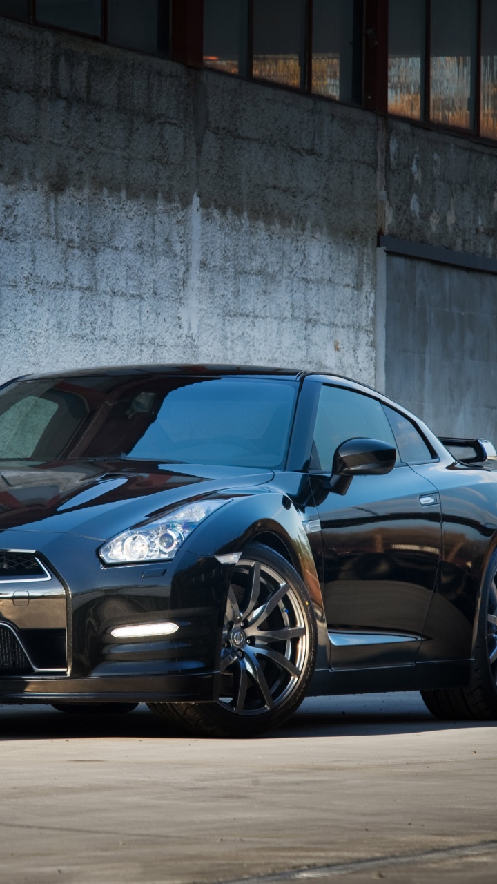 Blue Porsche 911 Parked Beside Wall. Wallpaper in 720x1280 Resolution