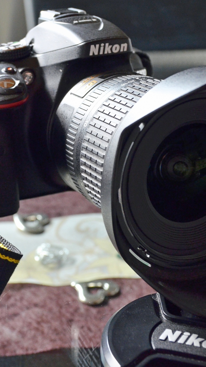 Black Nikon Dslr Camera on Brown and Black Textile. Wallpaper in 720x1280 Resolution