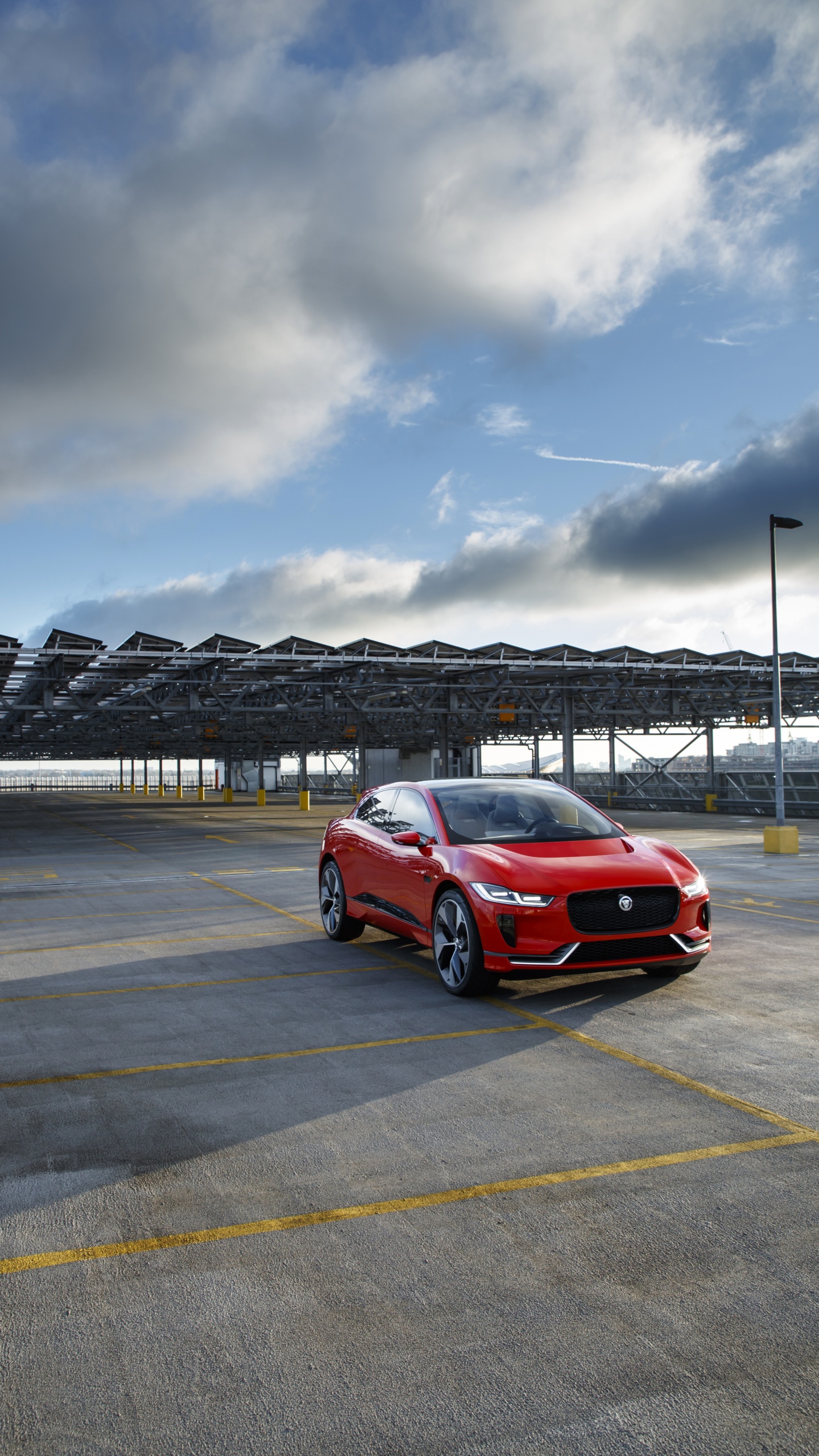 Red Car on Gray Asphalt Road Under Gray Cloudy Sky During Daytime. Wallpaper in 1440x2560 Resolution